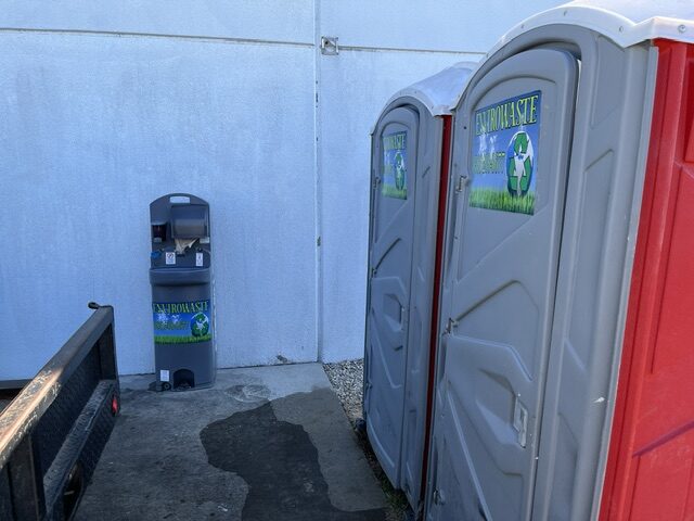 Single Envirowaste portable toilet on a residential framing site at sunrise